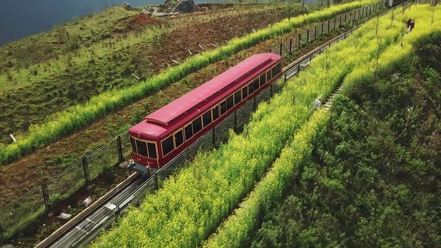 Low follow with train red carriage.  Vietnam sightseeing entertainment Travel. Transport delivery. Aerial flight