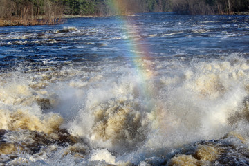 rainbow and rushing water by dam on Wisconsin River