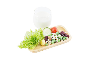 Cereal Grains, fresh vegetable on Wood tray and milk on white background, selective focus (detailed close-up shot)