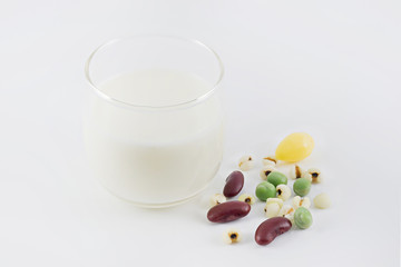 milk in glass and Cereal Grains on white background, selective focus (detailed close-up shot)