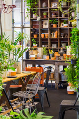 Working space and shelf with garden tools in cozy home garden on summer.