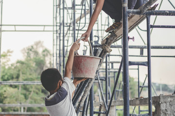 Children working at construction site for world day against child labour concept: