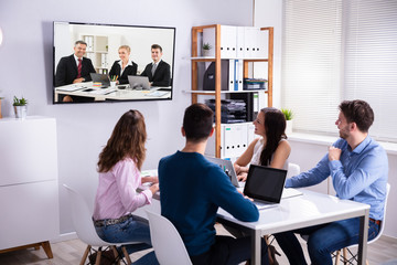 Business People Attending Videoconference Meeting