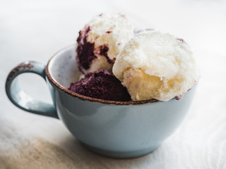 Bright, fruit ice cream on a vintage plate. White, isolated background. Close-up, top view. Concept of tasty and healthy food
