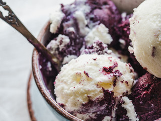 Bright, fruit ice cream on a vintage plate. White, isolated background. Close-up, top view. Concept of tasty and healthy food