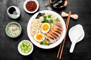 Traditional Japanese soup ramen with meat broth, asian noodles, sliced pork and eggs .  Asian style food. 