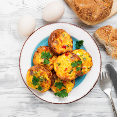 Delicious egg muffins with meat, cheese and vegetables .