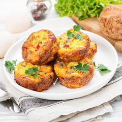 Delicious egg muffins with meat, cheese and vegetables .