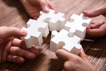 Businesspeople Solving Jigsaw Puzzle Together