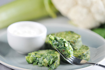 Vegetable patties from shinah, zucchini and cauliflower. Next to the meatballs cup with sauce. The concept of healthy eating. Close-up. Macro shooting.