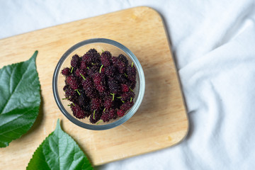 Fresh mulberry fruit on wood table background