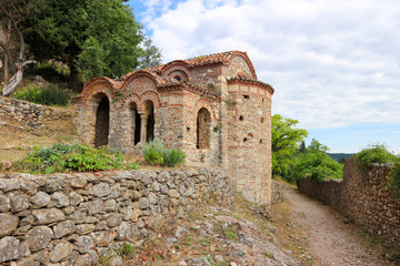 Fototapeta na wymiar Little byzantine church with arch windows on the street of abandoned medieval town Mystras, Peloponnese, Greece