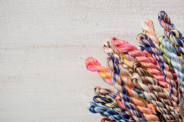 Colorful braided thread for embroidery. Free text space