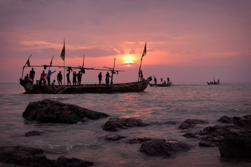 Fishing boat and fishermen at sunrise in Senya Beraku, Ghana - obrazy, fototapety, plakaty