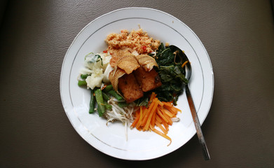 Sayur urap.  Cooked vegetables with spiced grated coconut. Indonesian traditional food.