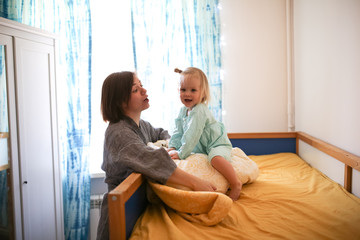 mom and daughter Toddler playing and hugging