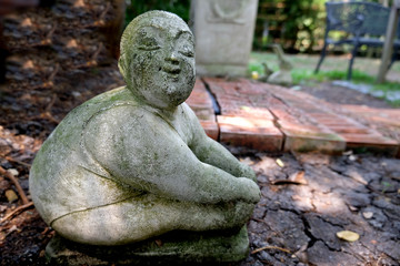 Fototapeta na wymiar statue of woman fat play yoga in garden