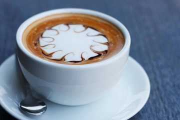 Cup of hot coffee latte on a wooden table natural beauty.