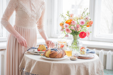 Tea time, Woman hands holding tea pot, flowers and cake