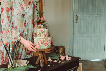 Tea time, Woman hands holding tea pot, flowers and cake