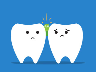 A green object stuck between teeth