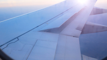 airliner wing raises flaps to prepare for landing