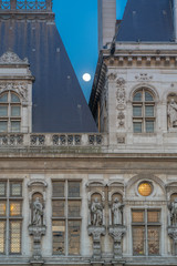 Fototapeta na wymiar Paris, France - 04 17 2019: Roof of the Paris City Hall at dusk with moon