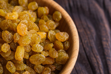 golden raisins on a wooden rustic background