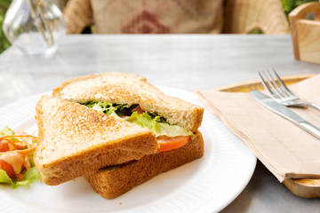 Breakfast, sandwiches, bacon and cheese and vegetables on the marble table