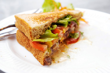 Breakfast, sandwiches, bacon and cheese and vegetables on the marble table