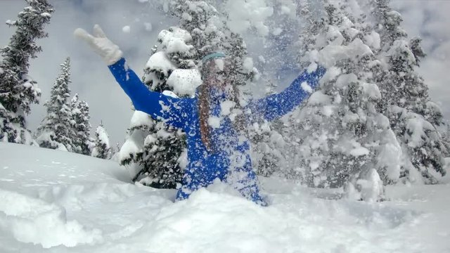The girl throws snow in a snowy forest slow motion. Christmas tree.