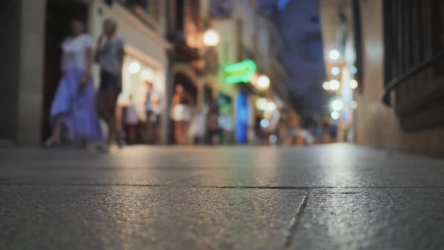 Shopping street in the tourist resort town of Catalonia Calella with tourists.