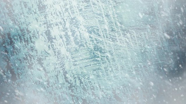 snowfall at winter season frozen glass surface background