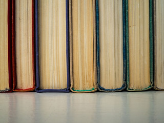 Old books of different flowers on the shelf. Postarvevshy pages of books. Paper books nice on the touch