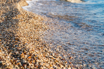 Close up beach stones on the seashore. Summer sunrise on coast, Corfu island, Greece. Beach Ionian sea. Wallpaper