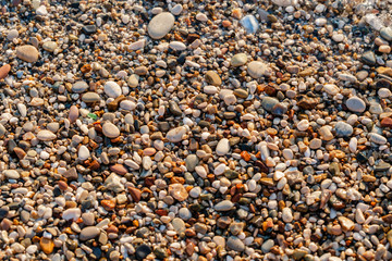 Close up beach stones on the seashore. Summer sunrise on coast, Corfu island, Greece. Beach Ionian sea. Wallpaper