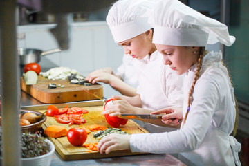children cooking lunch in a restaurant kitchen.
