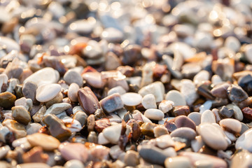 Close up beach stones on the seashore. Summer sunrise on coast, Corfu island, Greece. Beach Ionian sea. Wallpaper