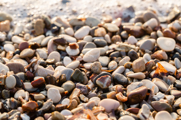 Close up beach stones on the seashore. Summer sunrise on coast, Corfu island, Greece. Beach Ionian sea. Wallpaper