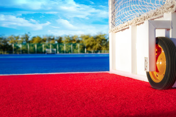 Modern Astroturf / artificial grass hockey field in red and blue