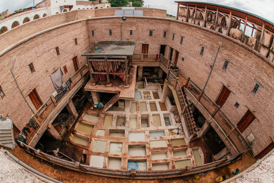 View inside of old medina in Fes, a traditional and old tannery with workers working making methods of leather in the city Fes, Morocco, in april of 2019. 