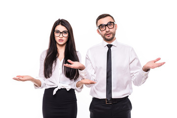 Two business partners in black suits, handsome man and beautiful woman shocked don't know what to do, isolated over white background. Teamwork concept