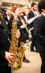 woman playing the saxophone with the music band