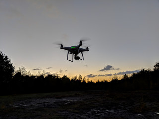 Fototapeta na wymiar Drone silhouette against sunrise