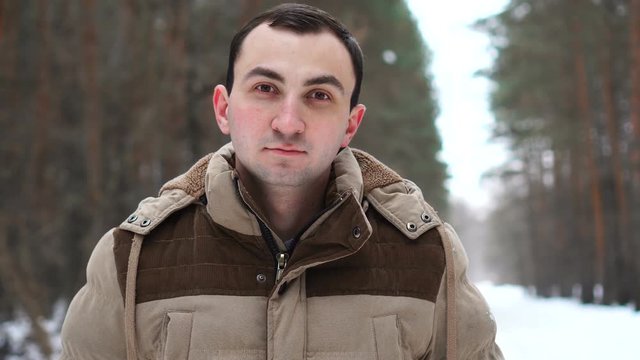 Portrait of young man in winter forest