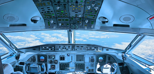 Cockpit of the airplane with sky view through a windshield