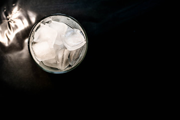 Ice in a glass on a black background