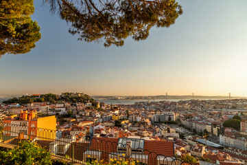 Lisbon cityscape postcard view from the viewpoint Miradouro da Senhora do Monte at sunset.