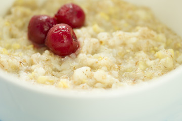 Tasty fresh breakfast . Oatmeal with frozen cherry .  tasty and healthy breakfast concept