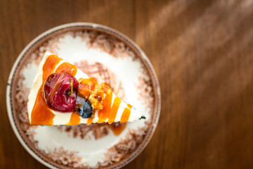 Dark beer chocolate cake (Chocolate Stout Cake) with caramel sauce and juicy fruits on top. Copy space